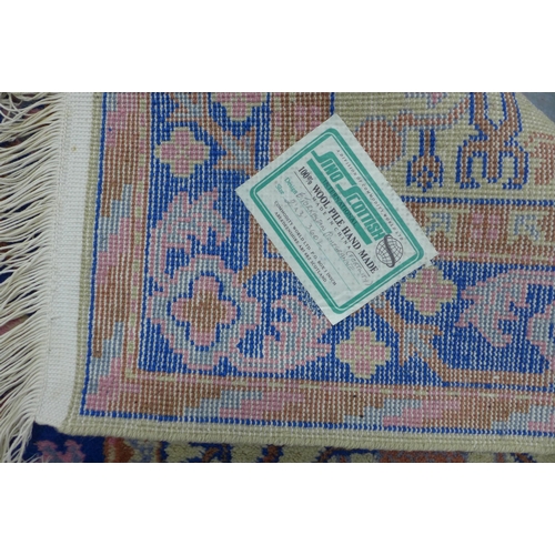 290 - Small wool rug, pomegranate pattern in pink and blue on a cream field, 90 x 62cm