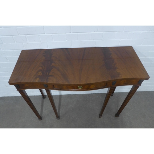 352 - Mahogany serpentine console table on tapering legs and spade feet, with one drawer, 107 x 83 x 43cm.