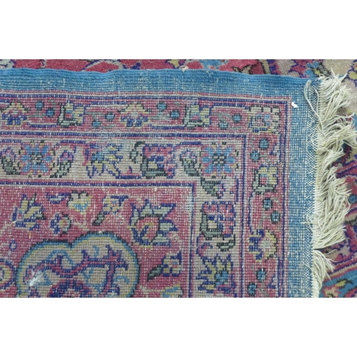 360 - Late 19th / early 20th century Country House  Persian carpet, with worn blue field and central folia... 