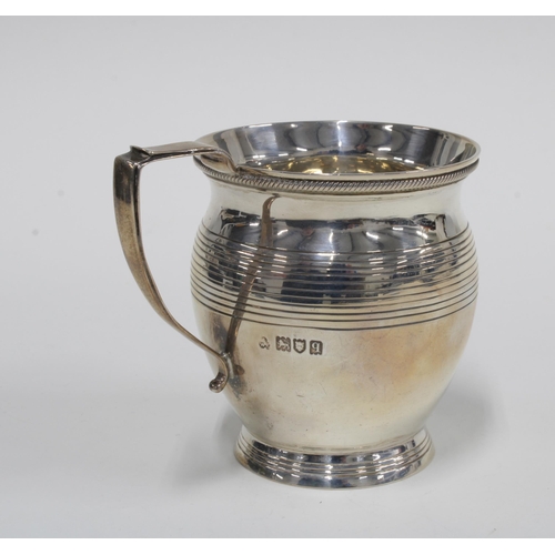 26 - George V silver christening mug, London 1911, 9cm high, with original leather case