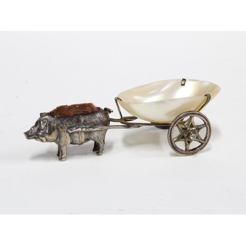 34 - An Edwardian novelty silver pig pin cushion, with a mother of pearl thimble holder cart, London 1905... 