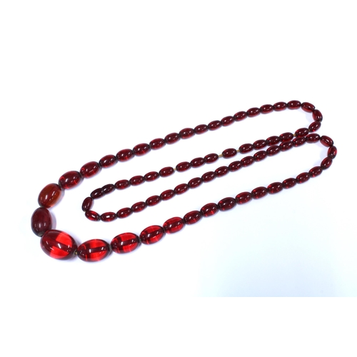 1 - A graduated strand of faux cherry amber beads, largest bead 3cm long
