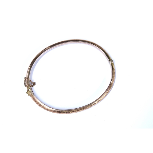 2 - An Edwardian 9ct gold bangle with foliate engraved pattern, Birmingham 1905, with fitted box