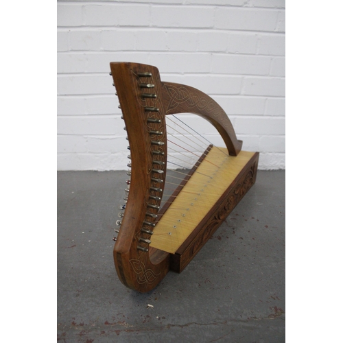 Table harp with celtic knot inlay and foliate carved base, 74 x 40cm