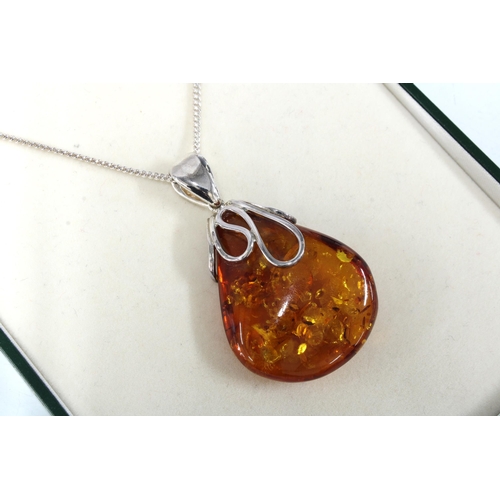 6 - Ortak silver and enamel pendant necklace, boxed together with a pair of knotwork earrings and an amb... 