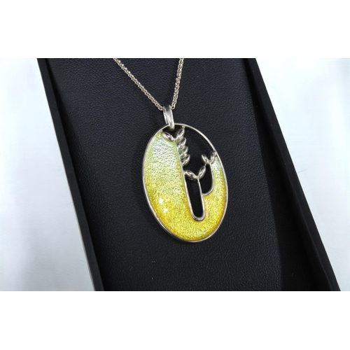 6 - Ortak silver and enamel pendant necklace, boxed together with a pair of knotwork earrings and an amb... 