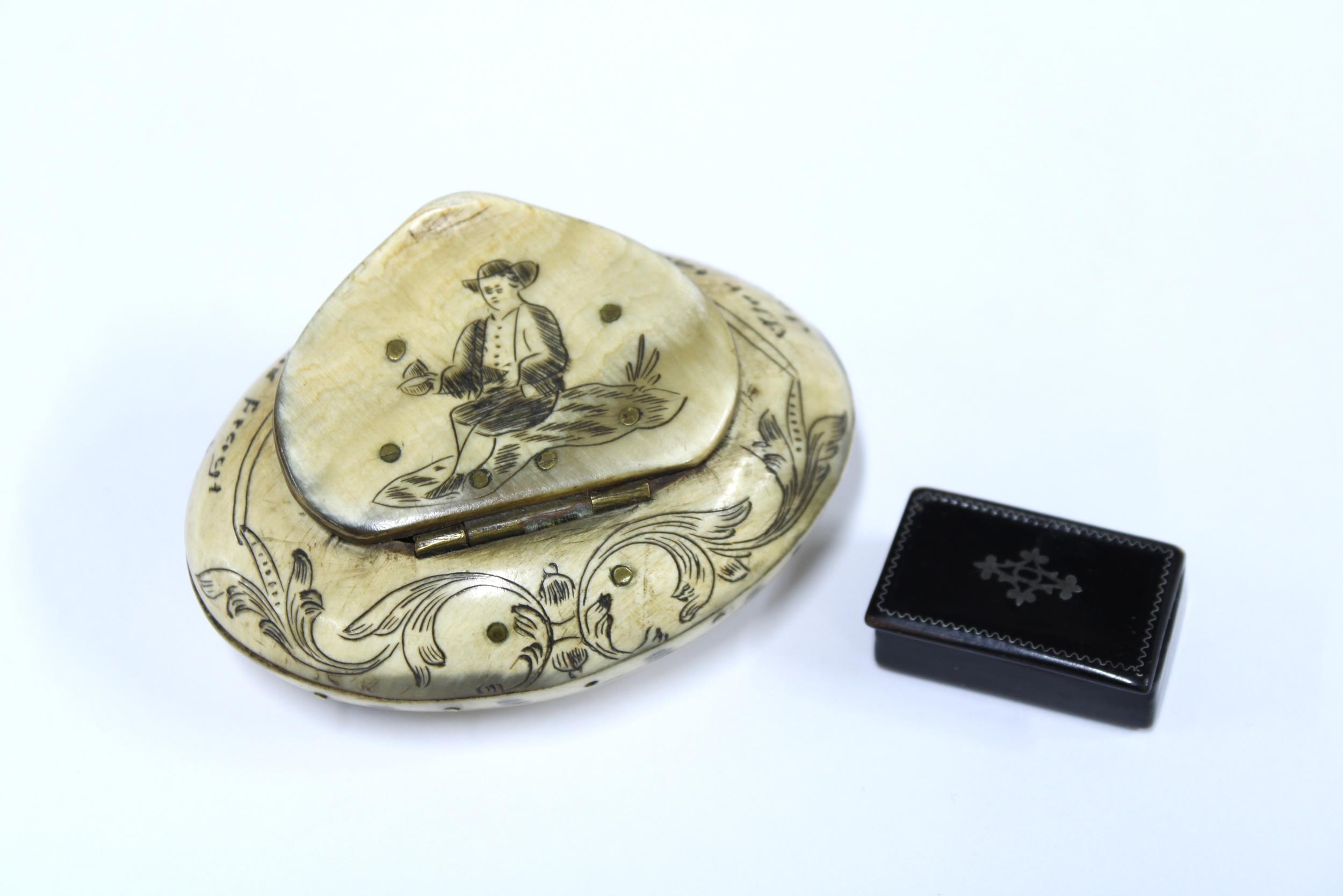 A small Georgian pique inlaid snuff box, 3cm long and a carved horn ...