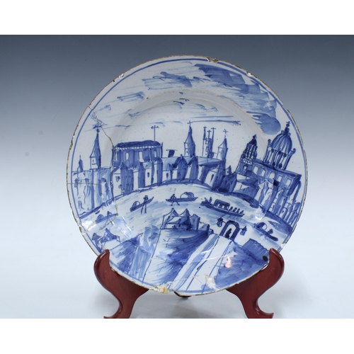 136 - Two large 18th century Delft blue and white tin glazed chargers / plates, together with a smaller ti... 