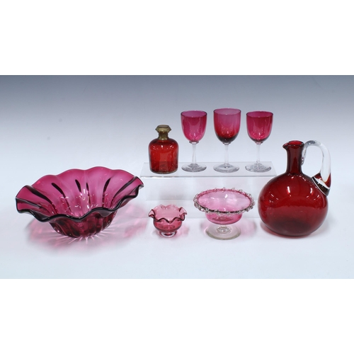 144 - Collection of cranberry glass, including a large frilled bowl 26cm diameter, three glasses, a jug, a... 