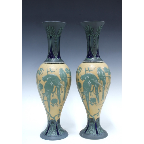 145 - Pair of early 20th century Villeroy & Boch Mettlach vases, each relief decorated with tropical birds... 
