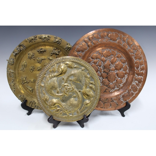 344 - Brass tripod footed tray relief decorated with animals, 33cm, together with a copper pierced floral ... 