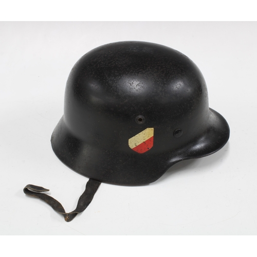 401 - German WWII steel helmet in black, with National Shield decal to one side and an indistinct decal to... 