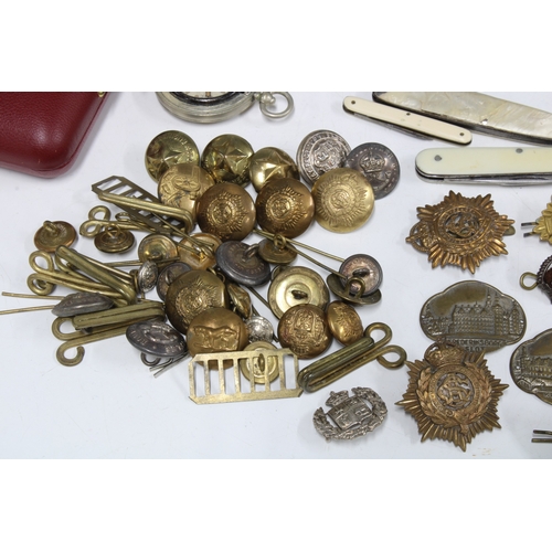 A collection of military cap badges, buttons, etc various pen / fruit ...