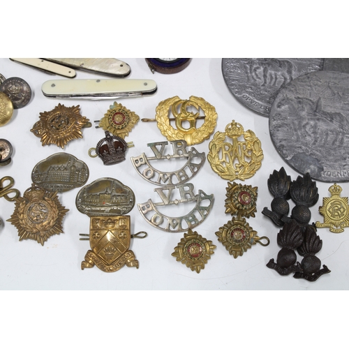 A collection of military cap badges, buttons, etc various pen / fruit ...