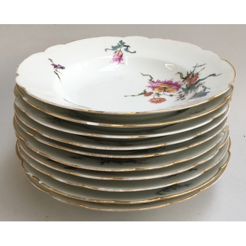 359 - A Haviland & Co Limoges porcelain dinner service, hand painted with floral sprays, the scalloped edg... 