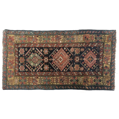 663 - A small Persian rug, three central lozenges surrounded by a triple border, 94x176cm