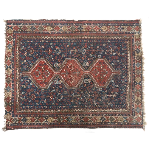 666 - A north-west Persian rug, the indigo field scattered with depictions flora and fauna, with three mad... 