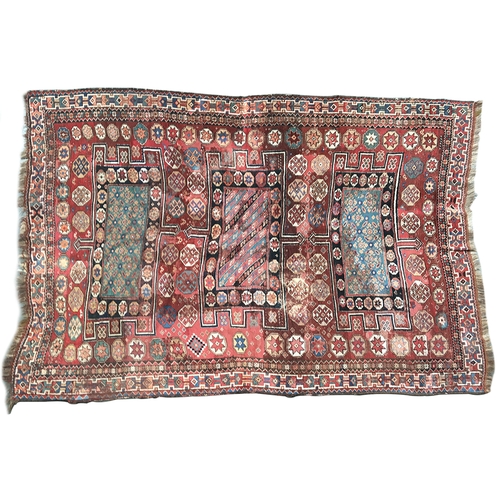 660 - A large complex geometric rug, of many colours, three central crenellated rectangles surrounded by g... 