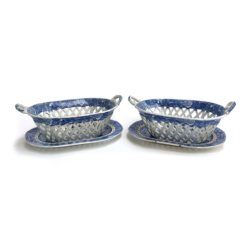 351 - A pair of English blue and white china pierced chestnut baskets of oblong form with twin scroll hand... 