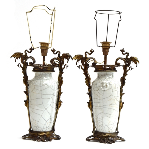 360 - A pair of Chinese ormolu mounted crackle glaze vases, each with dragon handles, adapted as lamps, wi... 