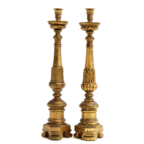 370 - A pair of giltwood altar candlesticks, probably Italian, on cylindrical stems, each decorated with b... 