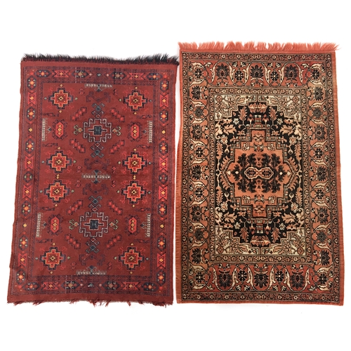 659 - Two wool pile Dutch table rugs in red toned Turkish patterns (130 x 82cm approx)