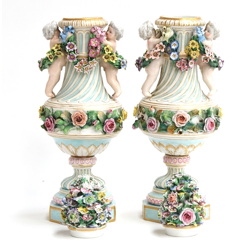 353 - A pair of 20th Century porcelain vases, each with flower-encrusted cover, the fluted urn-shaped bodi... 