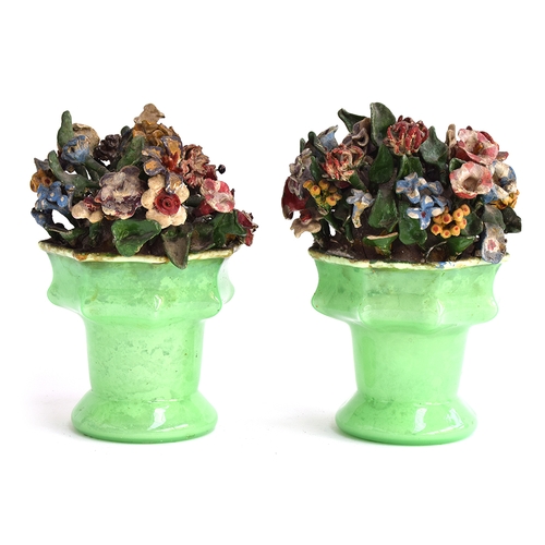 341 - A pair of late 19th century ceramic flower arrangements in green glass vases, 20cmH

Provenance: fro... 