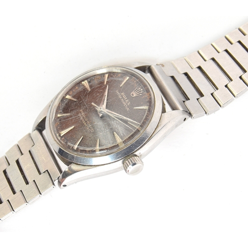 82 - A GENTLEMAN'S STAINLESS STEEL ROLEX OYSTER PERPETUAL WRIST WATCH
CIRCA 1958, REF 6564, BLACK TROPICA... 