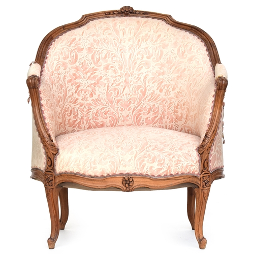 647 - A 19th century Louis XV style carved beech bergere, on cabriole legs covered in pink and white chint... 