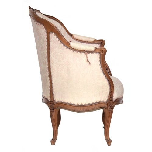 647 - A 19th century Louis XV style carved beech bergere, on cabriole legs covered in pink and white chint... 