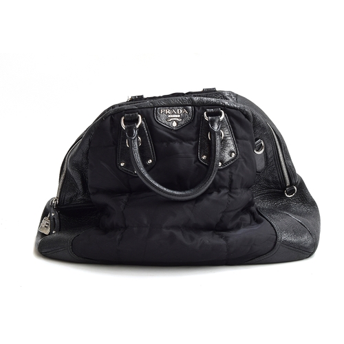 677 - Big soft nylon and black patent leather handbag from Prada, silver zip and padlock, good black jacqu... 