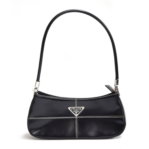 678 - Small firm black leather handbag from Prada with hinged silver hardware holding the handle, very goo... 