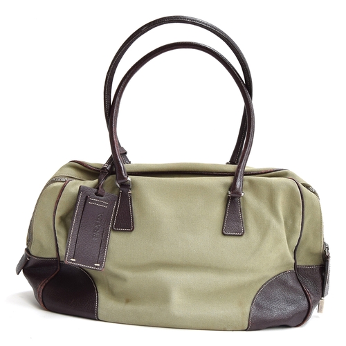 679 - Canvas and leather bowling bag from Prada with leather handles and elbows, zipped closure and padloc... 