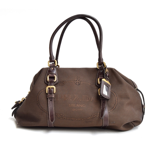 681 - Prada handbag in brown logo jacquard with leather handles and trim and brass zip and buckles, padloc... 