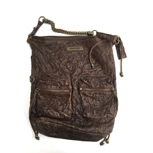 682 - Large brown leather shoulder bag from Thomas Wyld with skull of studs on one side and two zipped poc... 