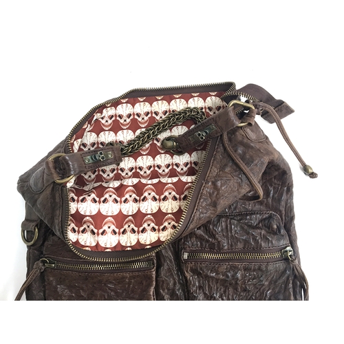 682 - Large brown leather shoulder bag from Thomas Wyld with skull of studs on one side and two zipped poc... 