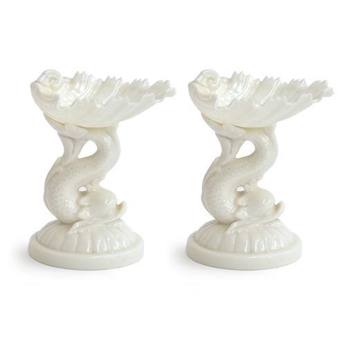 352 - A pair of Royal Worcester shell sweetmeat dishes in white, supported on the tail of a dolphin, shape... 