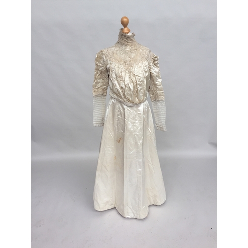 707 - Ivory satin skirt and blouse from 1890s, the blouse has subtle gigot sleeves with ruched band of sil... 