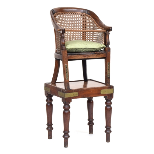 511 - A Victorian mahogany child's high-chair on stand, the curved frame with caned back support and spind... 