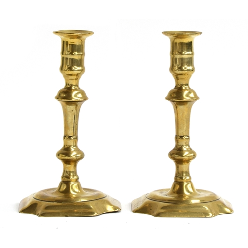 492 - A pair of brass candlesticks by Joseph Wood and George Grove, cut corner bases, brazing lines in bot... 