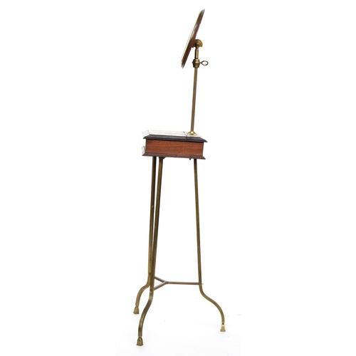 501 - A 19th century mahogany shaving stand with adjustable circular bevelled mirror, on a brass tripod su... 