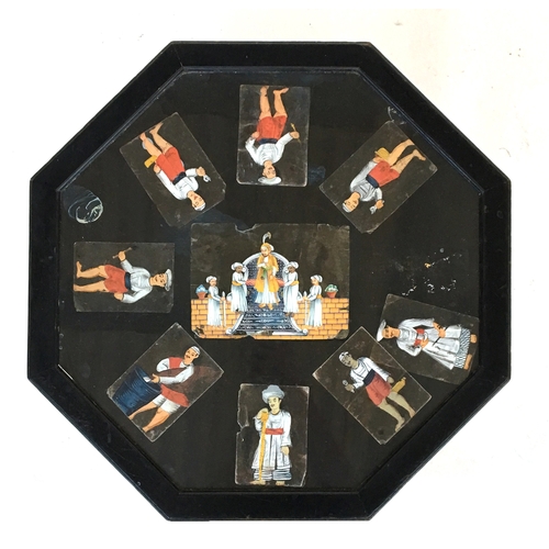 506 - An ebonised octagonal occasional table with undershelf, the glass top with nine Indian paintings of ... 