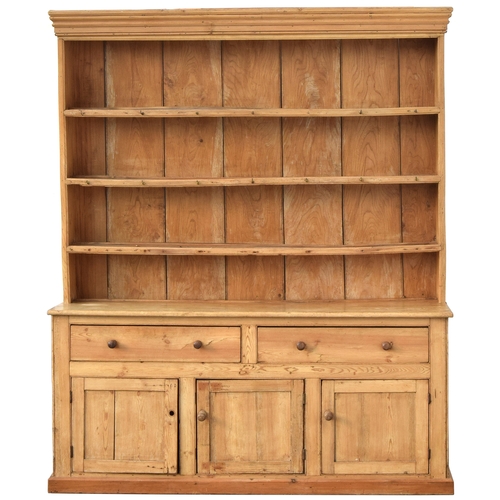 509 - A magnificent 19th century kitchen dresser, the oak top with three large shelves, over a pine base, ... 