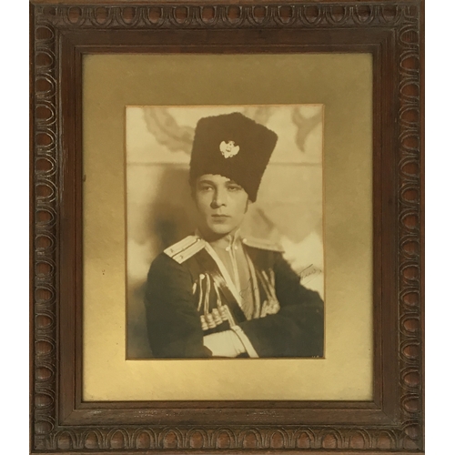 308 - A framed print of Rudolph Valentino, in costume as Lt. Vladimir Dubrovsky from the 1925 film 'The Ea... 