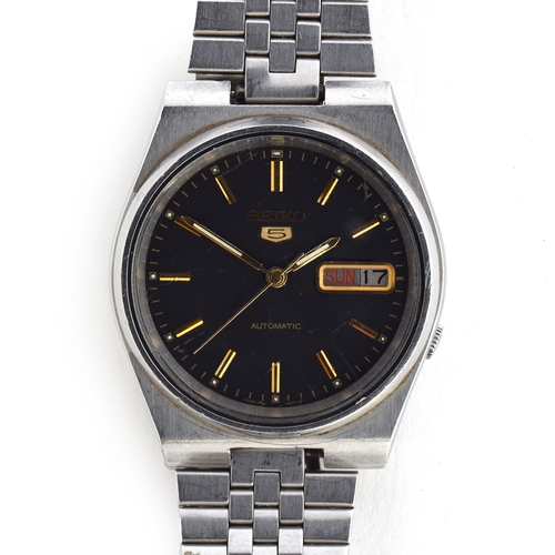 649 - A SEIKO 5 STEEL AUTOMATIC WRIST WATCH
circa 1980s, black dial raised gold baton markers, straight lu... 