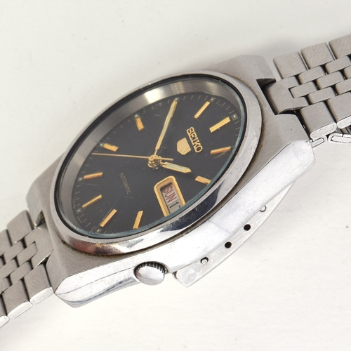 649 - A SEIKO 5 STEEL AUTOMATIC WRIST WATCH
circa 1980s, black dial raised gold baton markers, straight lu... 