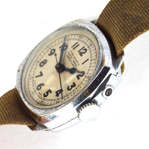 599 - A SIRO (ORIS) CHROMED MILITARY STYLE WRIST WATCH
Cira 1930, engine turned dial, Arabic numerals, blu... 