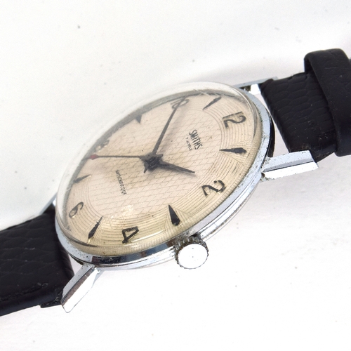 625 - A SMITHS 1950s GENT'S STEEL WATCH
Silvered fancy engine turned dial, raised Arabic numerals on evens... 