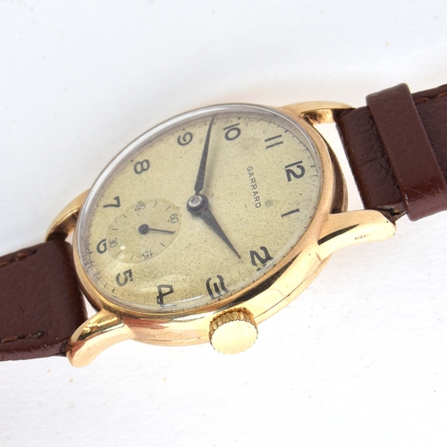 668 - A GARRARD 9CT GOLD GENTLEMAN'S WRIST WATCH
Circa 1950s, Arabic numerals and dagger hands
Movement: 1... 